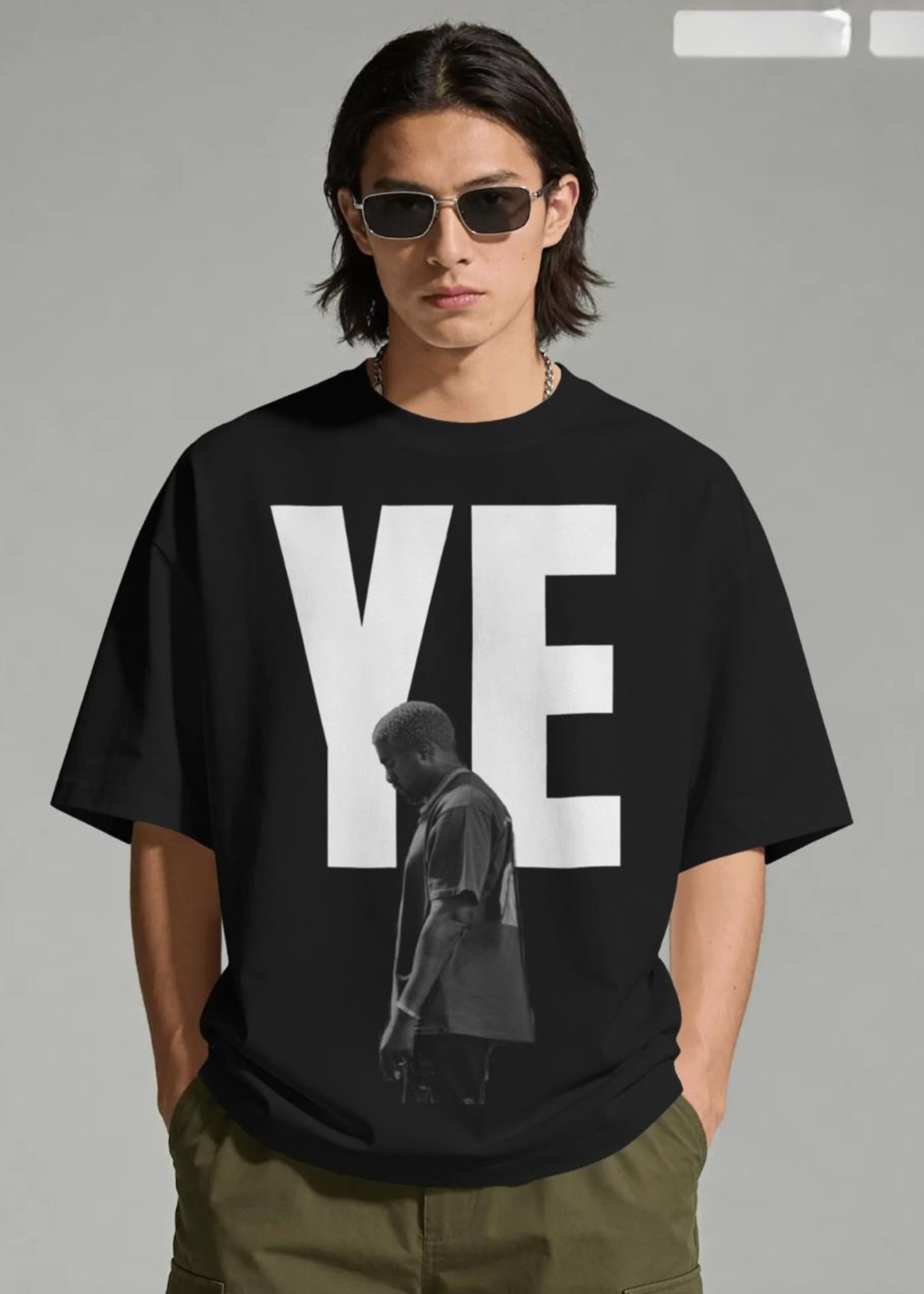 Person wearing a black t-shirt with 'YE' and a silhouette of a person on a gray background