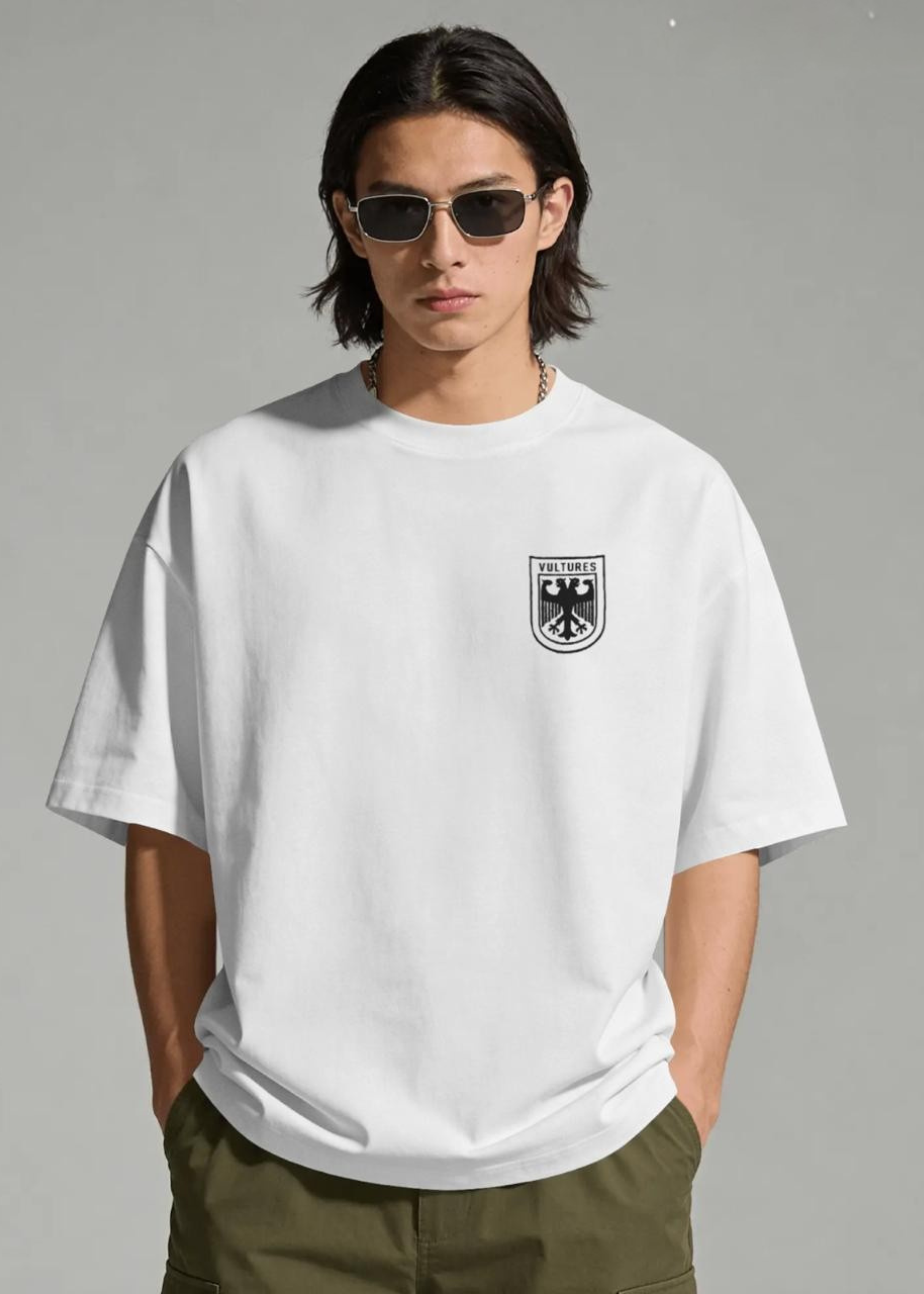 Person wearing a white t-shirt with a logo on a gray background