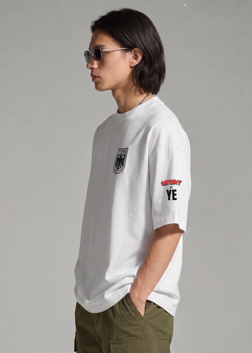 Person wearing a white t-shirt with graphics and text, standing against a plain background