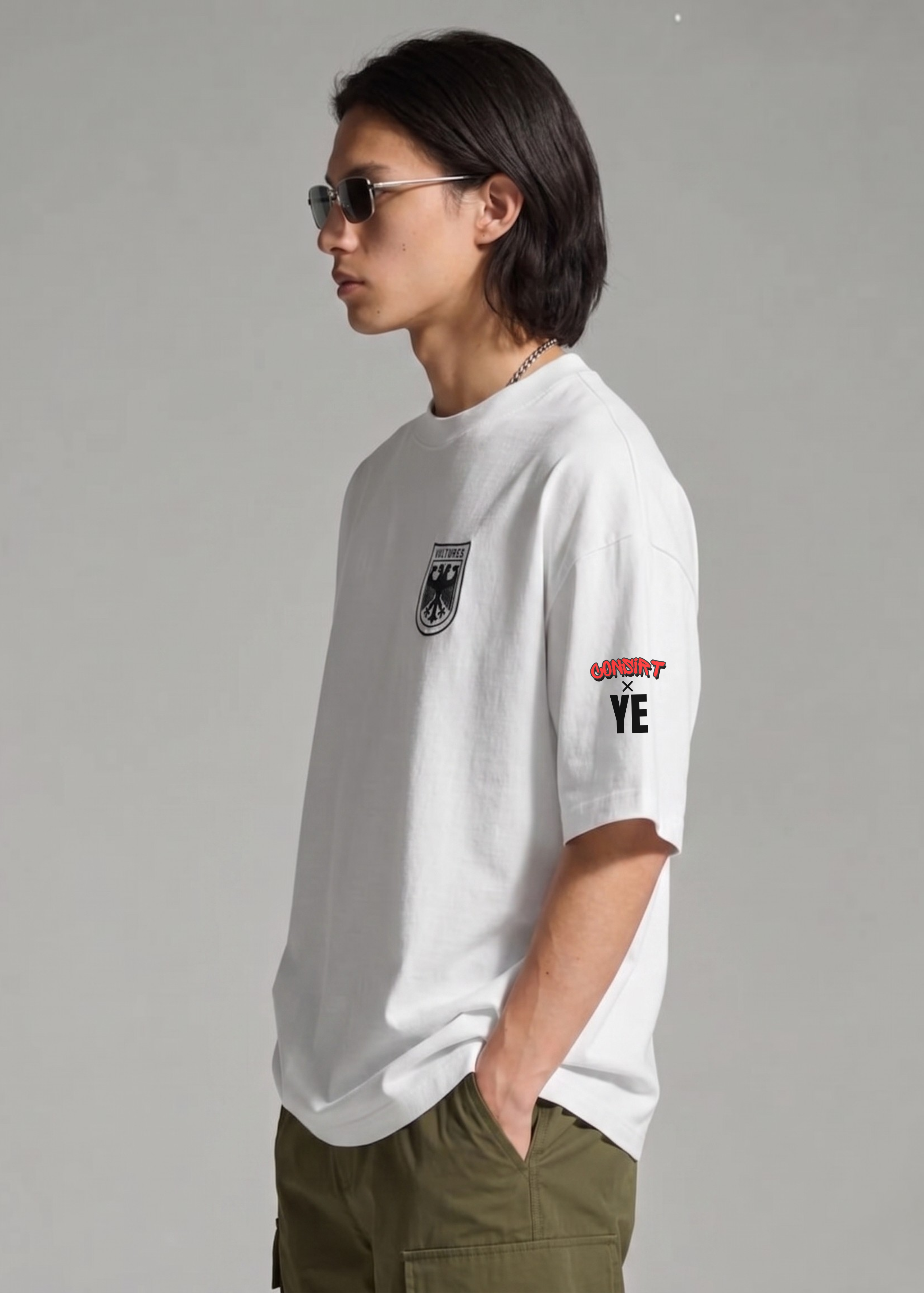Person wearing a white t-shirt with graphics and text, standing against a plain background