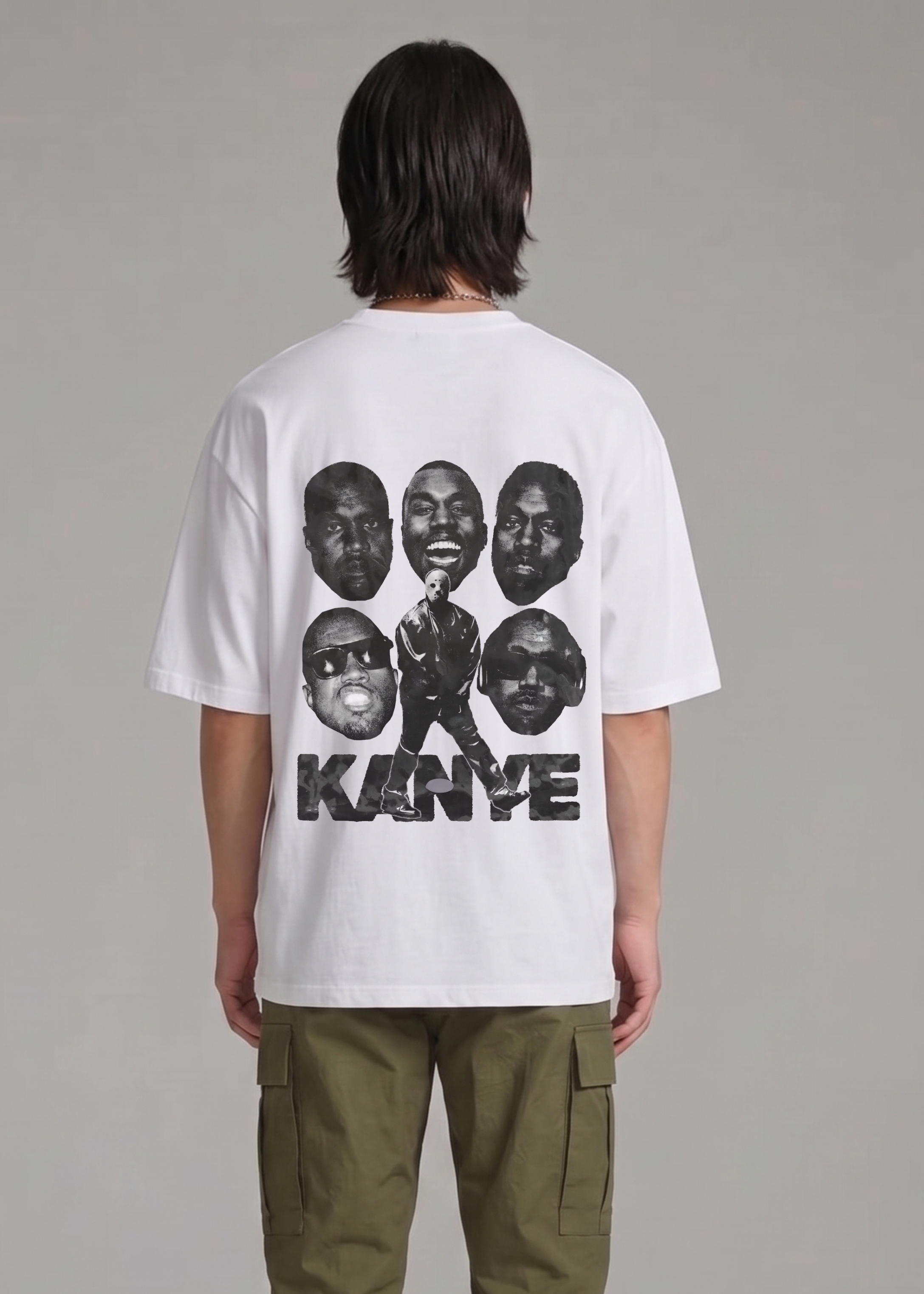 Person wearing a white t-shirt with graphic designs on the back, standing against a plain background